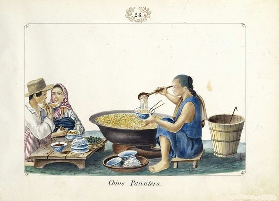 An old illustration showing two people eating pancit at a low wooden table, with a Chinese man serving noodles from a large wok.